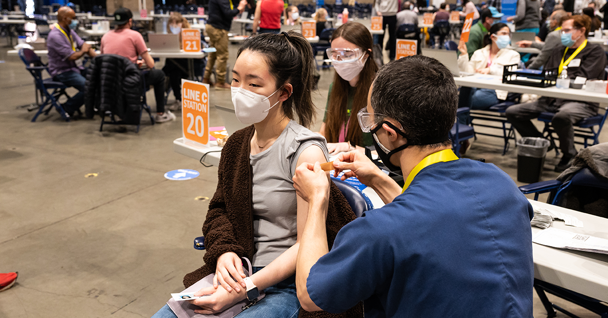 Photo: Person getting vaccinated at Lumen Field Event Center