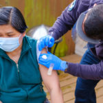 Photo: Person getting vaccinated by Seattle Fire at pop-up clinic