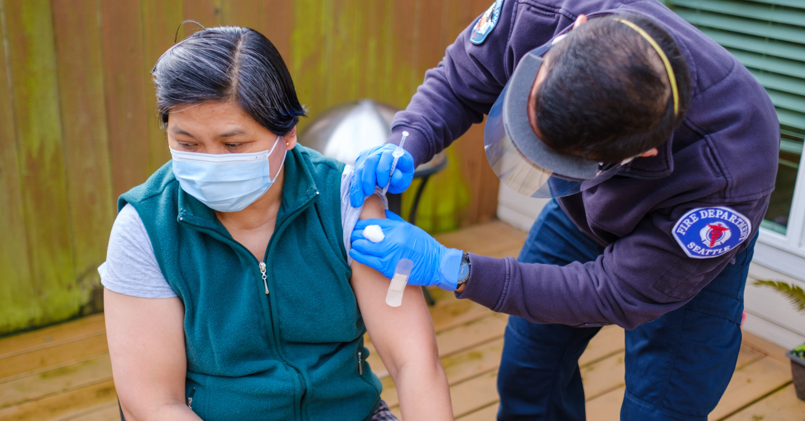 Photo: Person getting vaccinated by Seattle Fire at pop-up clinic