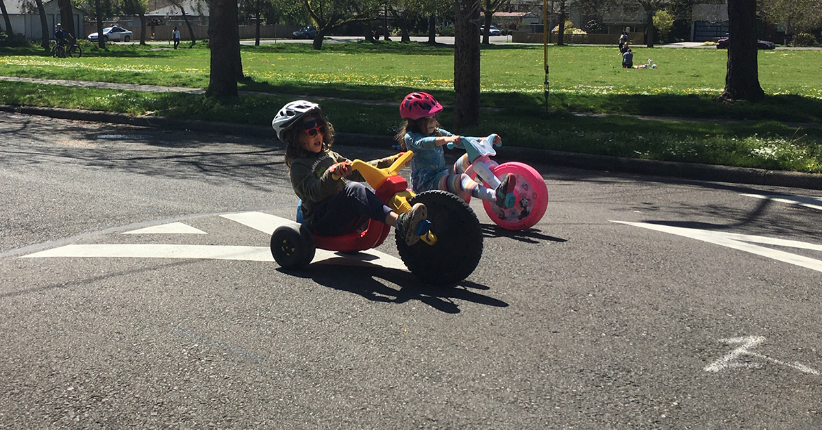 Photo: Kids tricycling on stay healthy street